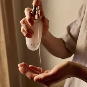 Close up of person dispensing Cellular Performance Emulsion 2 from bottle to hand 